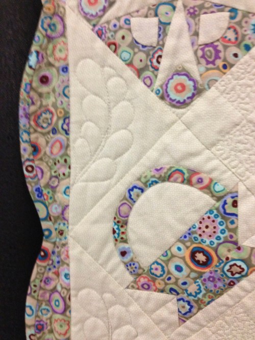 Close-up shows a bright Kaffe Fassett print and lovely scalloped border.