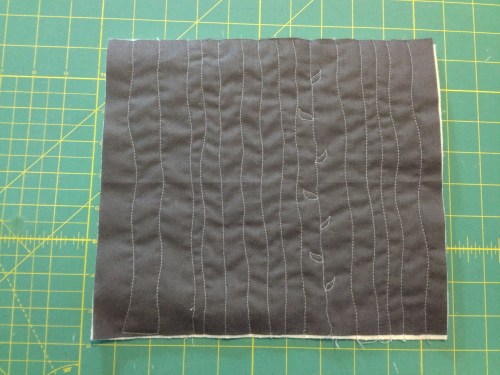 Quilted wavy lines and added some leaves to one line just for fun.