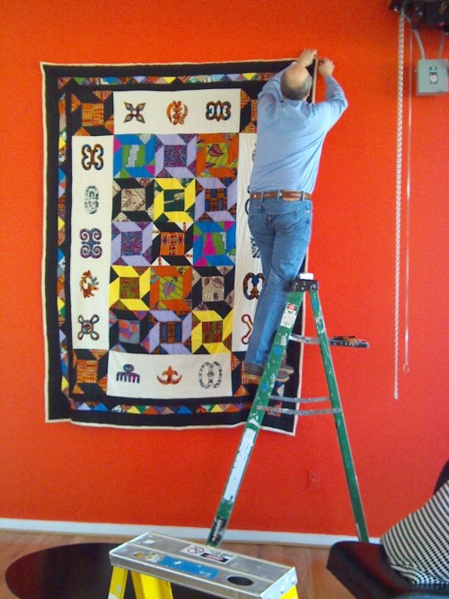 My husband hanging the largest quilt in the exhibit.