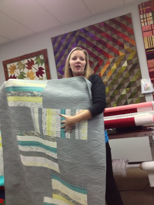 Angela showing one of her quilts.